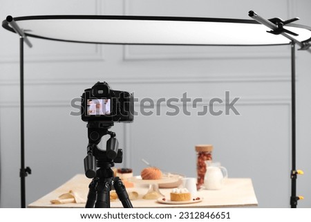 Professional camera with picture of beautiful composition on display in photo studio. Food stylist