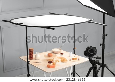Professional equipment and composition with delicious desserts on table in studio. Food photography