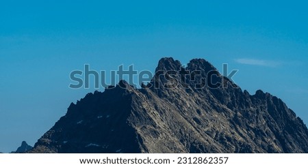 Two summits Vysoka mountain peak with lowest Tazky stit mountain peak in autumn Vysoke Tatry mountains in Slovakia