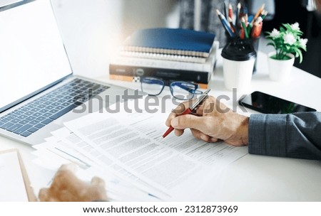 Businessman working on laptop reviewing document reports reading email and meeting online. legal expert, professional lawyer reading and checking financial documents or insurance contract