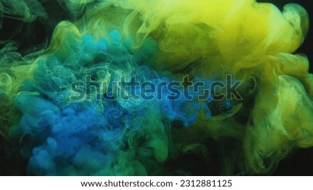 Color smoke. Paint water mix. Toxic fume. Chemical explosion. Green blue mist cloud blend floating on dark black abstract art background.