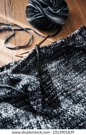 dark coloured hand knitted wool jumper