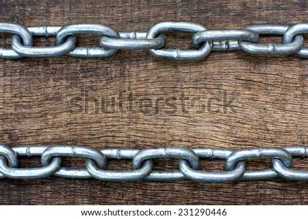 chain horizontal position at the top and bottom in the old cracked wooden background