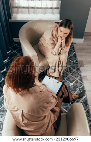 Counseling and therapy patient talking of problem, health expert listening. Therapist comforting a patient. Psychotherapy session, woman talking to his psychologist. Woman talking to her psychologist. Royalty-Free Stock Photo #2312906697