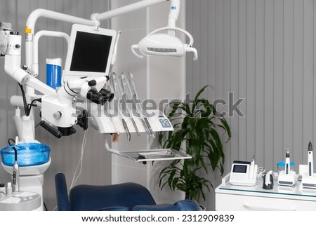 Dentist's office with modern chair and professional equipment. Camera movement around office. Modern interior with display and monitor, instrument and light. Microscope and chair. Royalty-Free Stock Photo #2312909839