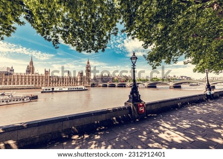 Big Ben, Westminster Bridge on River Thames in London, England, UK as seen from park walkway Royalty-Free Stock Photo #2312912401