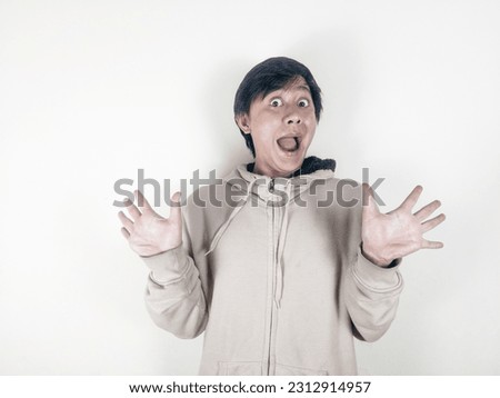 Surprised face of happy asian man in white background