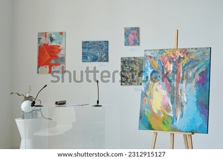 Horizontal image of modern colorful painting on canvas standing in art gallery