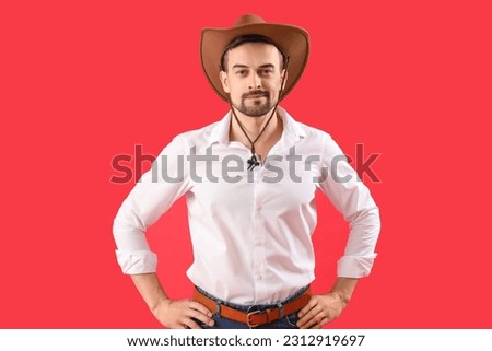 Handsome cowboy on red background