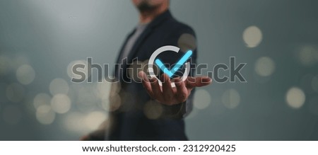 Service guarantee, Validation concept for business process automation, quality assurance management, certification, digital transformation. Businessman show checked icon on hand. Quality control. Royalty-Free Stock Photo #2312920425