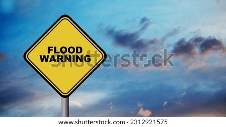 flood warning sign on cloudy sky background	