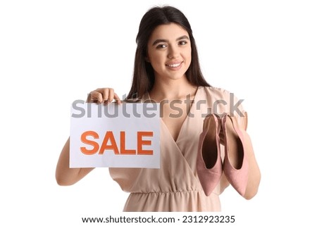 Female seller with sale sign and stylish shoes on white background