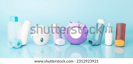 Set of asthma inhalers for asthma and COPD patients on blue background. Pharmaceutical product is used to treat lung inflammation and prevent asthma attack symptoms. Health care and medical concept. Royalty-Free Stock Photo #2312923921