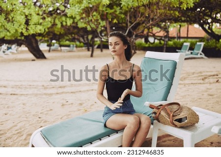 woman sand resort sunbed sea lying ocean chair beach lifestyle smiling