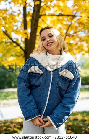 beautiful happy smile young woman wear casual cloth in autumn forest. Pretty cheerful happy girl model.