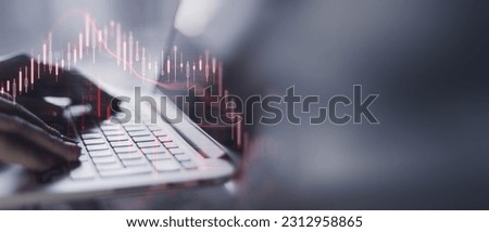 Businesswoman in a office analyzes complex crisis market data on a dlaptop. Detailed financial graphs indicate a high-pressure, data driven work environment, forex background Royalty-Free Stock Photo #2312958865