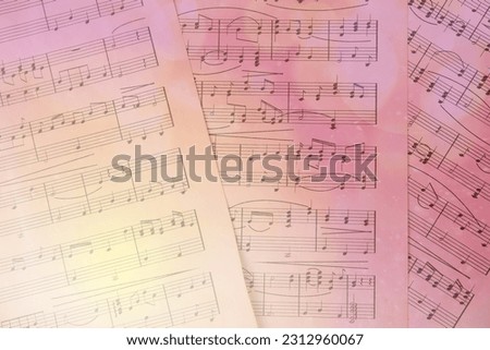 Sheets with music notes as background, top view. Bokeh and color tone effects