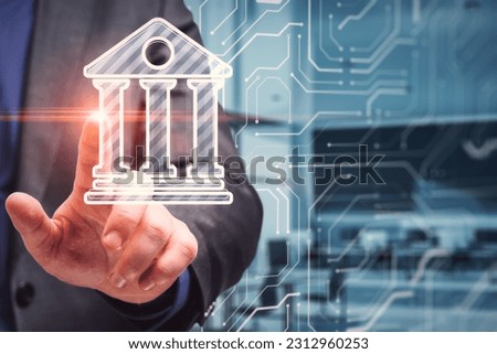 Online internet banking technology concept with businessman touching virtual screen with digital bank symbol on abstract office with microcircuit background