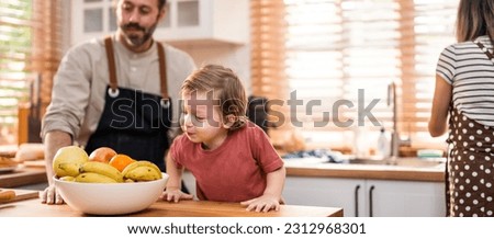 Caucasian attractive couple baking bakery with son in kitchen at home. Happy Family-father, mother and young boy having fun spending time together using ingredient making foods. Activity relationship.