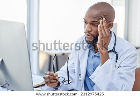 Stress, black man and doctor with a headache, frustrated or burnout with a computer error, glitch or health issue. Male person, employee or medical professional with a migraine, technology or anxiety Royalty-Free Stock Photo #2312975425