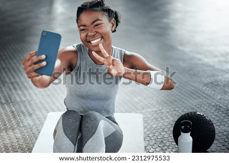 Black woman, gym selfie and peace with smile on floor for fitness, workout and wellness on social media app. Influencer girl, photography and blog for exercise, icon and health for lifestyle in club Royalty-Free Stock Photo #2312975533