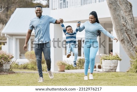 Happy parents lifting their kid by their new home in the outdoor garden while playing together. Backyard, bonding and African mother and father holding their boy child in the backyard of their house. Royalty-Free Stock Photo #2312976217