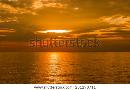 Golden sea and cloudy sky before sunset