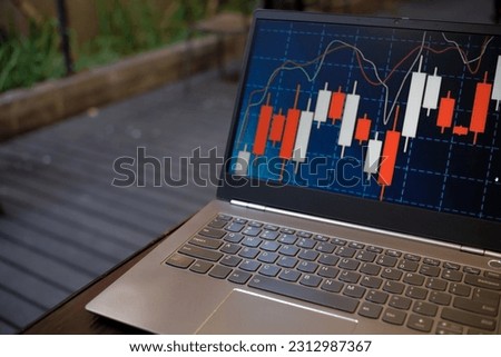 Visualizing Market Patterns: Close-Up View of a Laptop and Keyboard Displaying Candlestick Chart