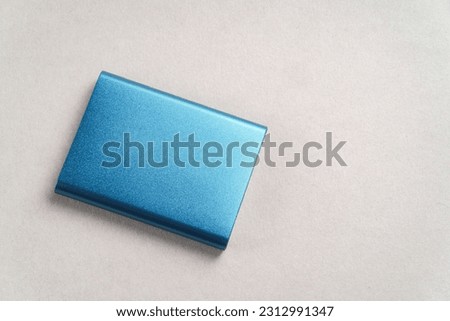 Portable SSD disk drive on gray background with copy space