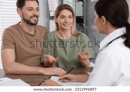 Couple having appointment with fertility doctor in clinic. Patient consultation Royalty-Free Stock Photo #2312996897