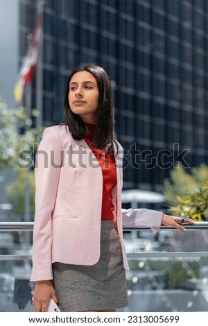 Portrait of beautiful pensive asian  woman holding mobile phone, waiting someone looking  away on the street