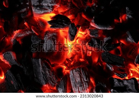 Pieces of hot smoldering coal as background, top view Royalty-Free Stock Photo #2313020843