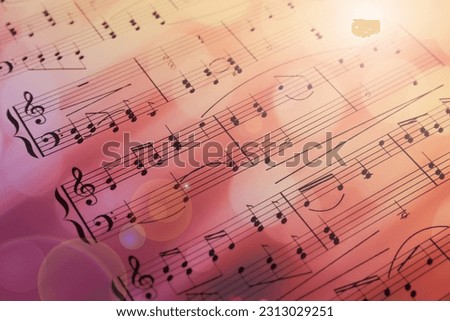 Sheet with music notes as background, closeup. Bokeh and color tone effects