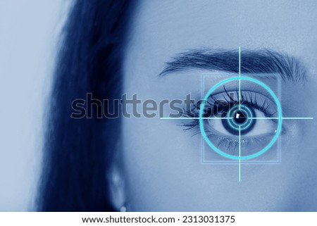 Vision test. Laser reticle focused on woman's eye, closeup. Light blue tone effect