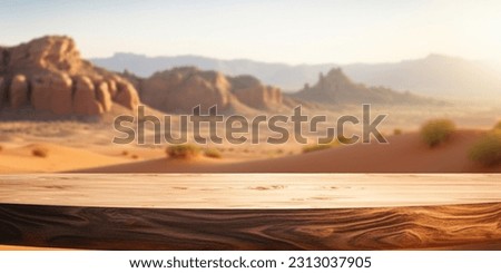 The empty wooden brown table top with blur background of desert dune mountain. Exuberant image.