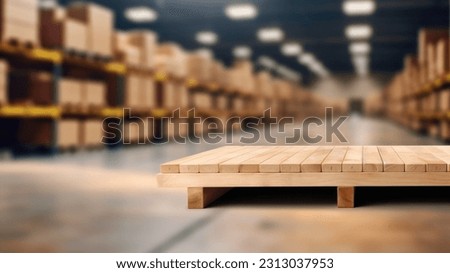 The empty wooden table top with blur background of warehouse storage. Exuberant image.