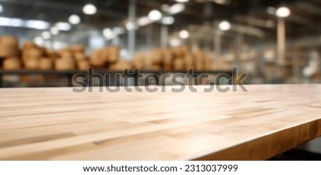 The empty wooden table top with blur background of factory. Exuberant image.