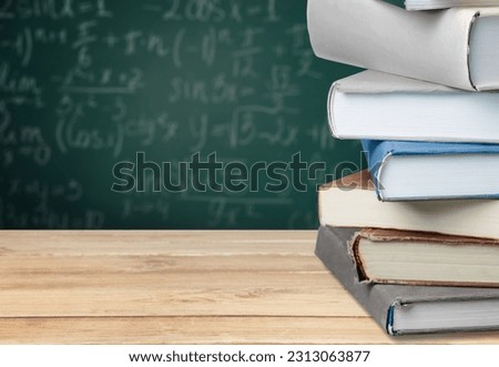 Math geometry formulas and books on board background