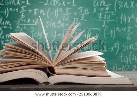 Math geometry formulas and books on board background