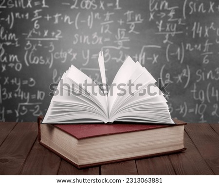 Math geometry formulas and books on board background Royalty-Free Stock Photo #2313063881