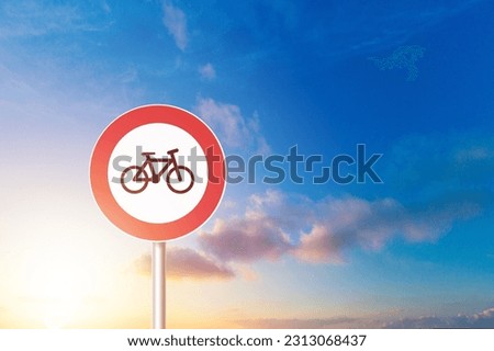 Round bicycle red sign on sky background.