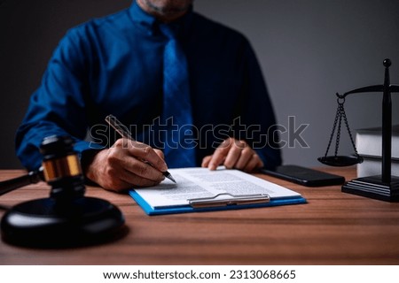 The immigration officer brought down the gavel of justice on the table, symbolizing the importance of following immigration law and the consequences of breaking it. passport, travel, tourism Royalty-Free Stock Photo #2313068665