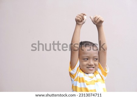Asian boy doing his hand as a great sign