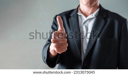 Close up Business man in Suit showing thumbs up, excellent sign, with right hand with copy space for Text. 