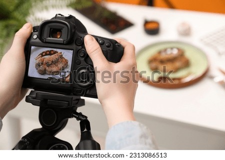 Food stylist taking photo of delicious meat medallion in studio, closeup. Space for text