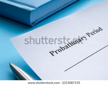 A sheet of paper with the inscription probationary period lies on the table. Royalty-Free Stock Photo #2313087135