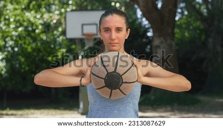 Portrait of Beautiful Young Woman Holding Basket Ball, Looking at the Camera and Smiling in Outdoor Court. Female Athlete Defying Stereotypes and Following her Dream of Going Professional