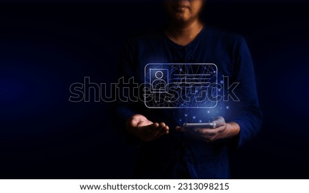 human hand holding digital ID card and smartphone, technology and business concept. Royalty-Free Stock Photo #2313098215