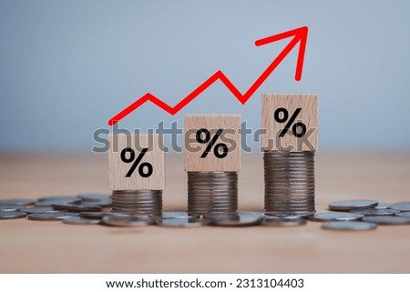 inflation concept, red graph arrow, Percentage sign on a wooden cube with rows of coins in idea for FED considers interest rate hike, world economics, and inflation control, US dollar inflation. Royalty-Free Stock Photo #2313104403