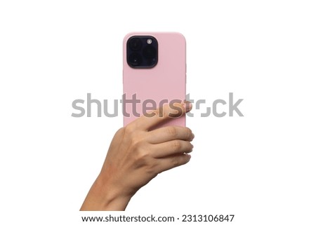 Mobile phone with 3 photo cameras in a pink case in female hand isolated on a white background. Blank with an empty copy space for the design. Mockup of a smartphone. A young woman takes picture